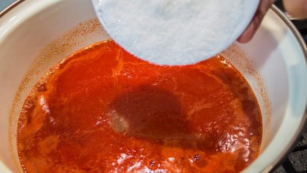 Thick homemade ketchup with starch from tomato juice for the winter